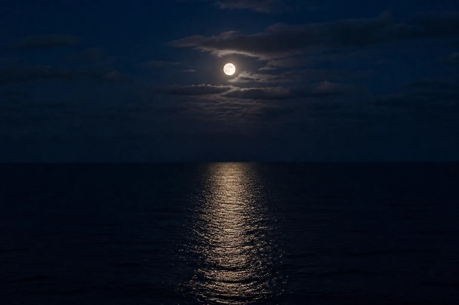 Moonlight reflected across dark quiet water.